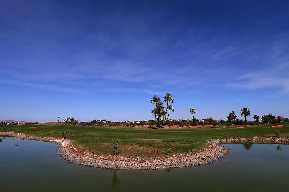 Amelkis Golf Club : lac bordé de galets, fairway, palmiers